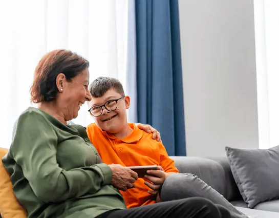 A boy with an intellectual disability and an adult with him